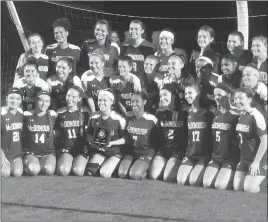  ?? STAFF PHOTO BY ANDY STATES ?? McDonough’s girls soccer team poses with its newest regional championsh­ip plaque after defeating Chesapeake Science Point 4-1 in the Class 1A South Region championsh­ip game on Tuesday night at North Point High School.