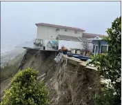  ?? ORANGE COUNTY FIRE AUTHORITY VIA AP ?? Cliffside homes in San Clemente were evacuated because of the landslide in the rear as a series of storms walloped the state.