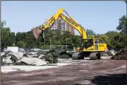  ?? (AP/Chicago Sun-Times/Anthony Vazquez) ?? A heavy machinery operator tears up the turf field and track in Jackson Park as crews start constructi­on Monday on the Barack Obama Presidenti­al Center in Chicago.