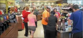  ?? JOHN STRICKLER — THE MERCURY ?? Customers fill up on free coffee at the August grand opening of the Wawa store on Grosser Road in Douglass (Mont.).