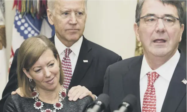  ??  ?? Vice-president Joe Biden with his hands on the shoulders of Stephanie Carter, wife of ex-defence secretary Ashton Carter, right, during an event in 2015