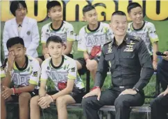  ??  ?? 0 Some of the boys with one of the Thai navy Seal divers