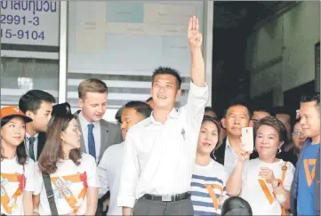  ??  ?? Thanathorn flashes a three-finger salute to his supporters as he leaves a police station after hearing a sedition complaint filed by the army in Bangkok, Thailand. — Reuters photo