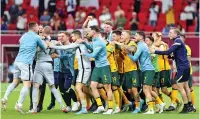  ?? ?? Australia players celebrate after securing WC qualificat­ion