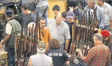  ?? Christina House For The Times ?? THE U.S. has by far the highest gun ownership rate on Earth — nearly 90 firearms for every 100 people. And no other developed nation comes close to us in firearms fatalities. Above, a 2012 gun show in Ontario.