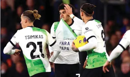  ?? Photograph: Clive Rose/Getty Images ?? Liverpool’s players show their support and gratitude for Luis Díaz after his late equaliser.