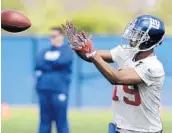  ?? JULIO CORTEZ/ASSOCIATED PRESS ?? Former FSU star Travis Rudolph, a free-agent signee, catches a pass as the Giants opened their rookie camp.