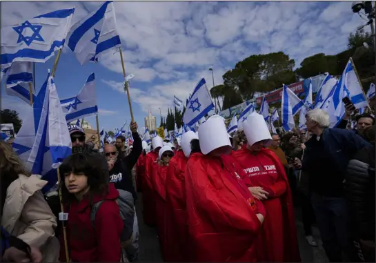  ?? OHAD ZWIGENBERG — THE ASSOCIATED PRESS ?? Israelis protest against plans by Prime Minister Benjamin Netanyahu’s new government to overhaul the judicial system outside the Knesset, Israel’s parliament, in Jerusalem on Monday.