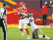  ?? Chris O’meara The Associated Pres ?? Linebacker Shaquil Barrett, pressuring Patrick Mahomes in the Super Bowl, is staying with the Bucs on a $72 million contract.