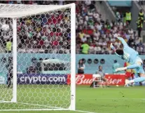  ?? — AFP ?? Iran goalkeeper Hossein Hosseini dives as England forward Bukayo Saka scores his team’s second goal.