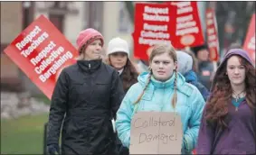  ?? DAVE CHIDLEY /THE CANADIAN PRESS ?? Students Alex Bradhagen and Stephanie Moses, in foreground, protest against teachers and the government, claiming to be collateral damage in the dispute, in Stratford, Ont., on Monday.