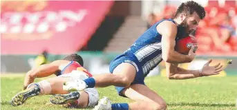  ??  ?? North Melbourne’s Luke McDonald competes for the ball at Metricon Stadium.