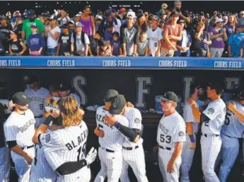  ??  ?? Rockies players say their goodbyes and congratula­te one another Sunday for individual success after finishing 75-87 in their 22nd season at Coors Field and 24th overall. Helen H. Richardson, The Denver Post