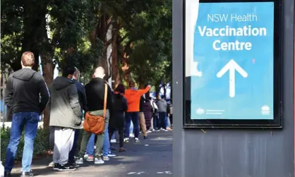  ?? Photograph: Mick Tsikas/EPA ?? People queue to receive their Pfizer Covid jab at the NSW vaccinatio­n hub at Sydney’s Olympic Park on Thursday.