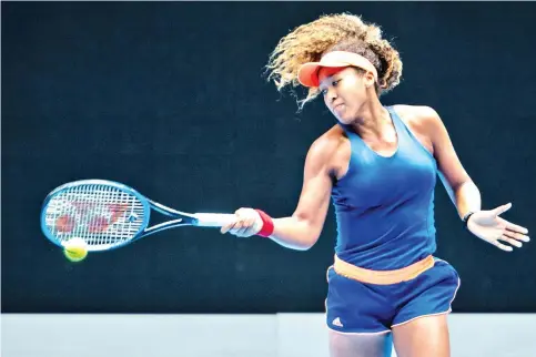  ??  ?? Japan's Naomi Osaka plays a forehand shot during a practice session in Melbourne, ahead of the Australian Open tennis tournament. - AFP photo