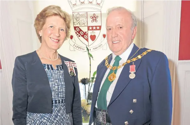  ?? ?? HONOUR: Councillor Colin Brown, right, receives the British Empire Medal from the Lord Lieutenant of Angus, Georgiana Osborne, in 2019.