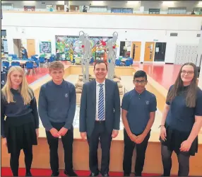  ??  ?? Alberto Costa MP alongside pupils from Brockingto­n Colleage in front of Remembranc­e Day display created by fellow students