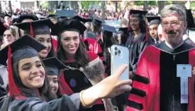  ?? PHOTO: REUTERS ?? Among fans . . . New Zealand Prime Minister Jacinda Ardern poses for a selfie with graduating students at Harvard University in Cambridge, Massachuse­tts yesterday.