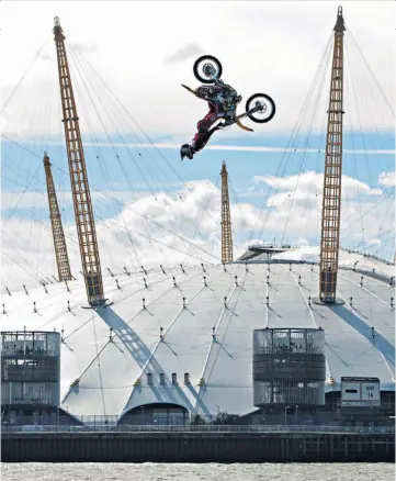  ??  ?? Publicity stunt: Travis Pastrana enjoys a different view of the Thames as he takes to the air near the O2 Arena to promote his show