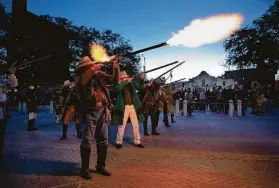  ?? Robin Jerstad / Contributo­r ?? A musket volley pierces the morning during the “Dawn at the Alamo” ceremony Saturday commemorat­ing the beginning of the siege of the Alamo in 1836.