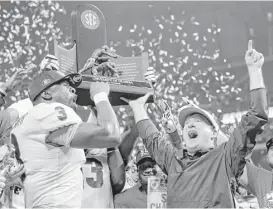 ?? C.B. Schmelter / Chattanoog­a Times Free Press ?? Georgia coach Kirby Smart, left, returned the Bulldogs to the top of the SEC, their first conference title since 2005, in only his second year as head coach.