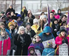  ?? KAYLE NEIS ?? Women’s March participan­ts listen to a guest speaker near River Landing on Saturday. About 400 people marched in the event.