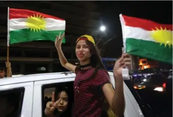  ?? SAFIN HAMED/AFP/GETTY IMAGES ?? Iraqi Kurds celebrate a 93-per-cent vote for independen­ce from Iraq in Monday’s non-binding referendum.