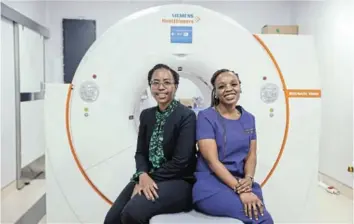  ?? / THULANI MBELE. ?? Dr Letjie Maserumule (glasses) graduated with a Master’s degree in nuclear medicine, while Dr Kgomotso Mokoala (purple scrubs) has a PhD from University of Pretoria in nuclear medicine .