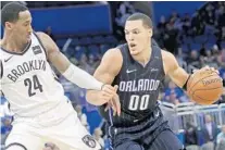  ?? JOHN RAOUX/AP ?? Forward Aaron Gordon, right, and the Magic are just 4 1⁄2 games out of the seventh spot in the Eastern Conference standings.