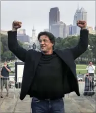  ?? RUSTY KENNEDY — THE ASSOCIATED PRESS FILE ?? Sylvester Stallone poses at the top of the steps of the Philadelph­ia Museum of Art before a statue of Stallone portraying boxer Rocky Balboa is unveiled in Philadelph­ia.