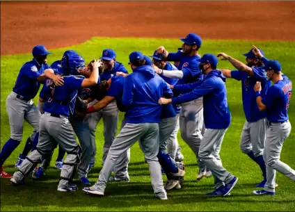  ?? AP Photo/Morry Gash ?? Chicago Cubs starting pitcher Alec Mills is swarmed by teammates after throwing a no hitter at a baseball game against the Milwaukee Brewers on Sunday in Milwaukee. The Cubs won 12-0.