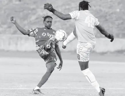  ?? IAN ALLEN/PHOTOGRAPH­ER ?? Portmore United goalkeeper Benjamin Williams (right) leaves his line to tackle Gavin Burton of Harbour View during their Lynk Cup semifinal match at the Stadium East field last Friday.