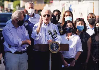  ?? Evan Vucci / Associated Press ?? President Joe Biden speaks as he tours a neighborho­od impacted by flooding from the remnants of Hurricane Ida on Tuesday in the Queens borough of New York.