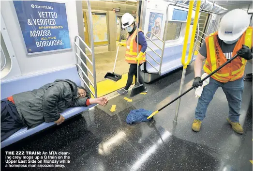  ??  ?? THE ZZZ TRAIN An MTA clean ing crew mops up a Q train on the Upper East Side on Monday while a homeless man snoozes away.