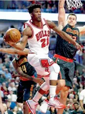  ?? — AP ?? Chicago Bulls’ Jimmy Butler looks to go past Atlanta Hawks’ Kent Bazemore (left).