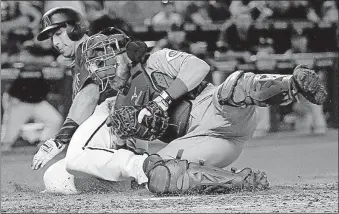  ?? YORK/THE ASSOCIATED PRESS] [MATT ?? The Diamondbac­ks’ Paul Goldschmid­t is tagged out at the plate by Reds catcher Tucker Barnhart in the sixth inning. Goldschmid­t was trying to score from second base on a single.