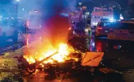  ?? Photo: EPA ?? A barricade is set on fire during clashes between fans of Morocco and riot police in the streets of Brussels.