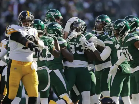  ?? ADAM HUNGER - THE ASSOCIATED PRESS ?? New York Jets linebacker Tarell Basham (93) celebrates an intercepti­on with teammates in the first half of an NFL football game against the Pittsburgh Steelers, Sunday, Dec. 22, 2019, in East Rutherford, N.J.