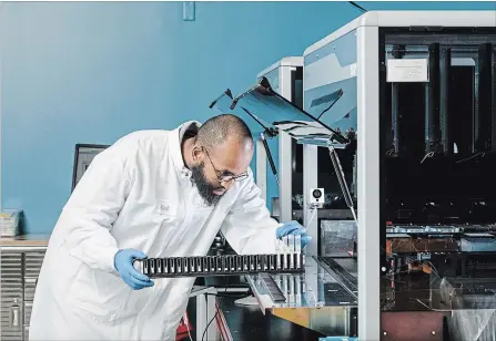  ?? JASON HENRY THE NEW YORK TIMES ?? Abdi Khalif works in the genomic testing lab at Color Genomics in Burlingame, Calif.