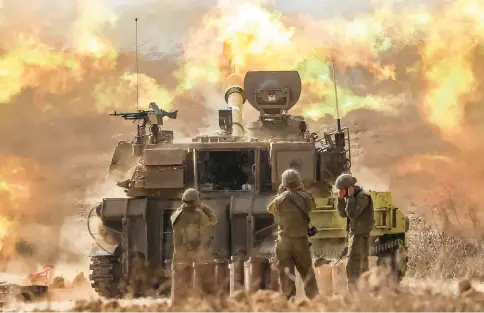  ?? JACK GUEZ/AFP VIA GETTY IMAGES ?? An Israeli army M109 155mm self-propelled howitzer fires rounds near the border with Gaza in southern Israel on Oct.11. Israel declared war on Hamas on Oct. 8 following a shock land, air, and sea assault by the Gaza-based militant group.