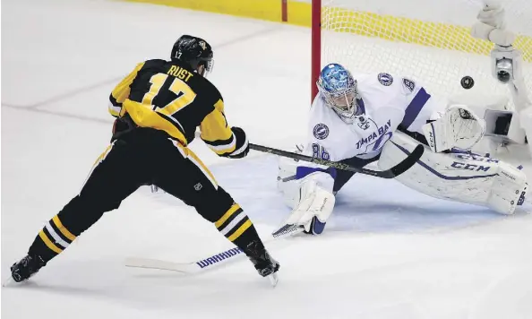  ?? GENE J. PUSKAR/ THE ASSOCIATED PRESS ?? Pittsburgh Penguins forward Bryan Rust is stopped by Tampa Bay Lightning goalie Andrei Vasilevski­y during the third period, but Rust scored both goals early in the night to lead the Penguins to a 2-1 win in Game 7 of the Eastern Conference Final on...