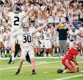  ?? ?? Arnold celebrates his game-winning kick with teammate Hudson Lilie as Ortiz can only watch as it sails true. Vandegrift’s win at the Alamodome extended the deepest playoff run in school history.
