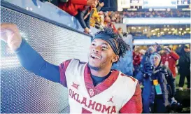  ?? IAN MAULE, TULSA WORLD] [PHOTO BY ?? Oklahoma Sooners quarterbac­k Kyler Murray shakes hands with fans after the Sooners’ win over West Virginia on Friday at Milan Puskar Stadium in Morgantown, W.Va.