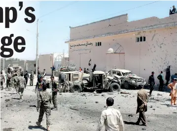  ??  ?? Afghan National Army (ANA) soldiers inspect damaged army vehicles after a suicide attack in Lashkar Gah, Helmand province, Afghanista­n August 23, 2017. Reuters