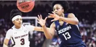  ?? Sean Rayford / Associated Press ?? UConn guard Christyn Williams receives a pass defended by South Carolina guard Destanni Henderson on Feb. 10 in Columbia, S. C.