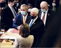  ?? Anna Moneymaker / New York Times ?? Vice President Mike Pence and House Speaker Nancy Pelosi, D-calif., speak after a joint session of Congress certified the Electoral College count at the Capitol after Trump supporters stormed and occupied the Capitol.