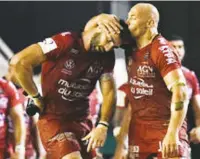  ??  ?? Victory kiss: Try-scorer Sergio Parisse embraces Charles Ollivon