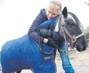  ?? SUSIE KOCKERSCHE­IDT METROLAND ?? Rae Ierullo of Forever Thyme Sanctuary hugs Oreo, who she helped nurse back to health.