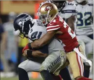  ?? NHAT V. MEYER — BAY AREA NEWS GROUP ?? The 49ers’ K’Waun Williams sacks and forces a turnover against Seattle Seahawks starting quarterbac­k Russell Wilson during a game in November.