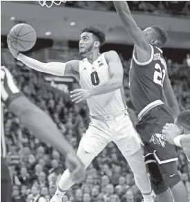  ?? MIKE DE SISTI / MILWAUKEE JOURNAL SENTINEL ?? Marquette guard Markus Howard drives to the basket past Villanova’s Dhamir Cosby-Roundtree. Howard scored 38 of MU’s 66 points Saturday.